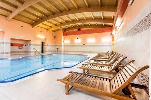 Young man and woman lying down on massage beds at Asian luxury spa and wellness center